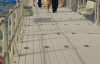 group of people walking down a pier