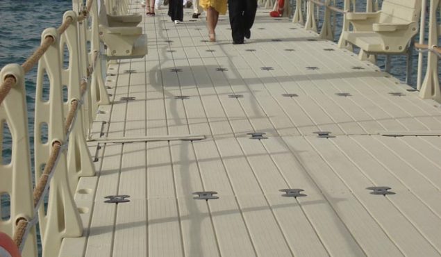 group of people walking down a pier