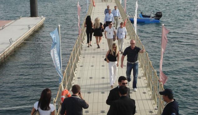 people wearing black on a pier