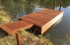 Decked pontoon with gangway and moorings for swimmers at Heckfield Place, Hampshire.