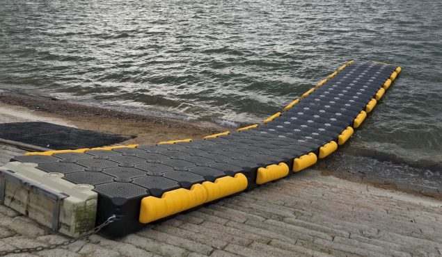 Modular cube pontoon with fenders used for sailing school