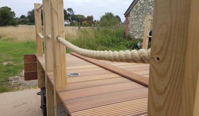 Decked pontoon being made with handrail posts and synthetic hemp rope