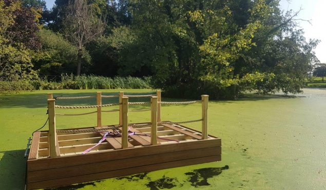 Decked pontoon with handrails, framework on show