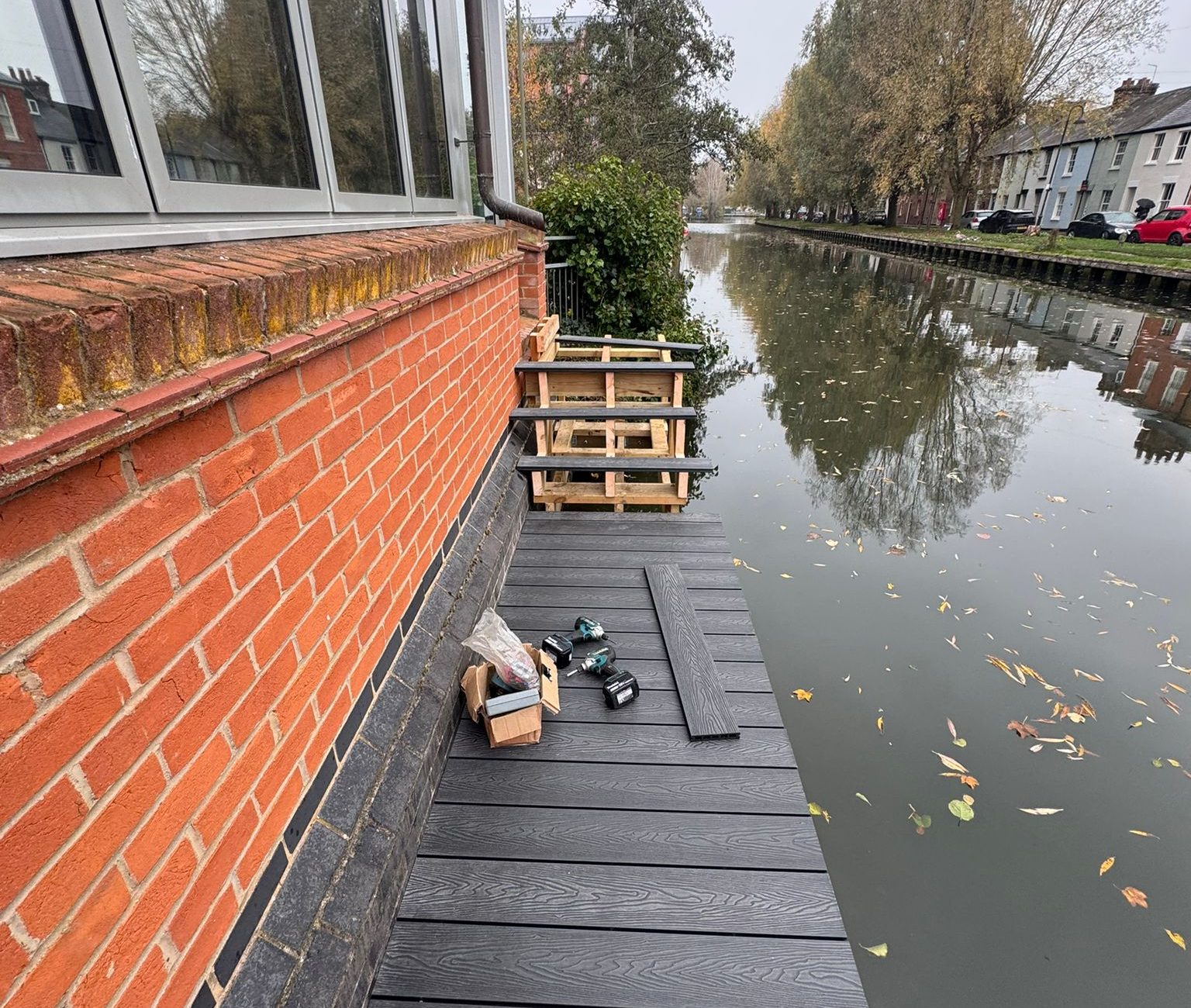 Most of the decking is laid, but the stairs are incomplete, and some tools and equipment are sat on the main platform.