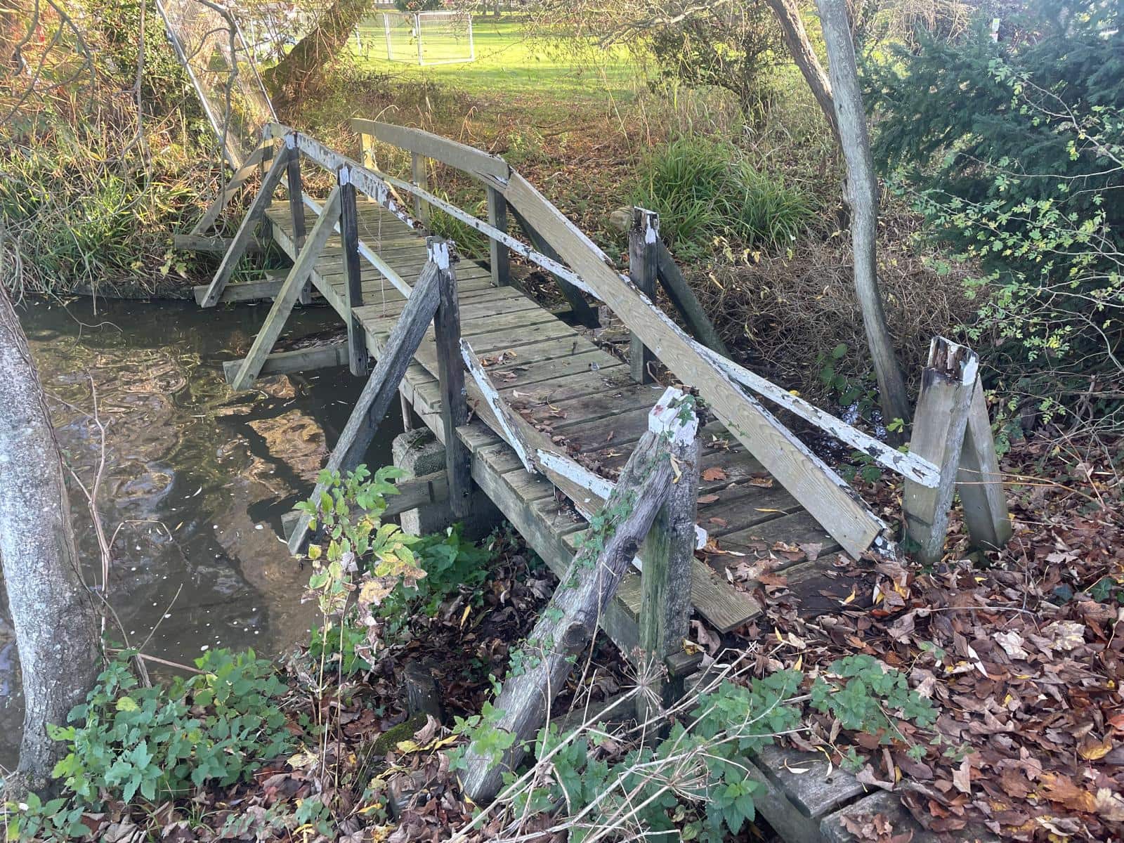 Broken wooden bridge across 9m gap over a waterway