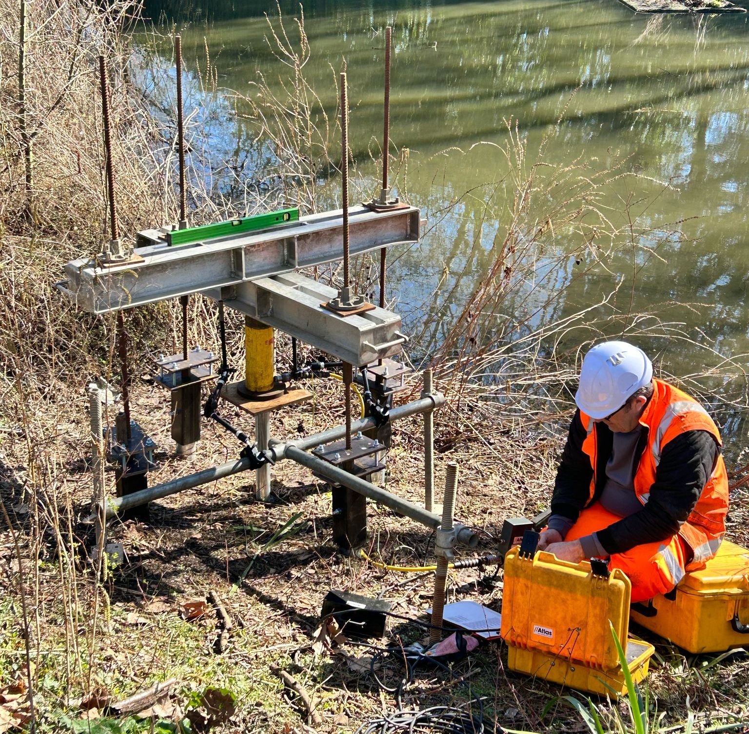 A workman in high-vis performing non-destructive testing on the site